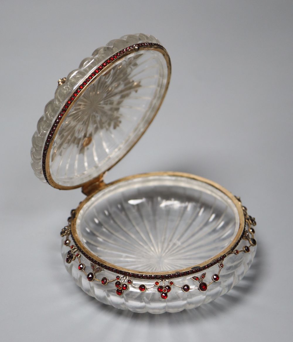 A Victorian yellow metal, cabochon and facet cut garnet mounted circular fluted glass powder jar, diameter 10.7cm.